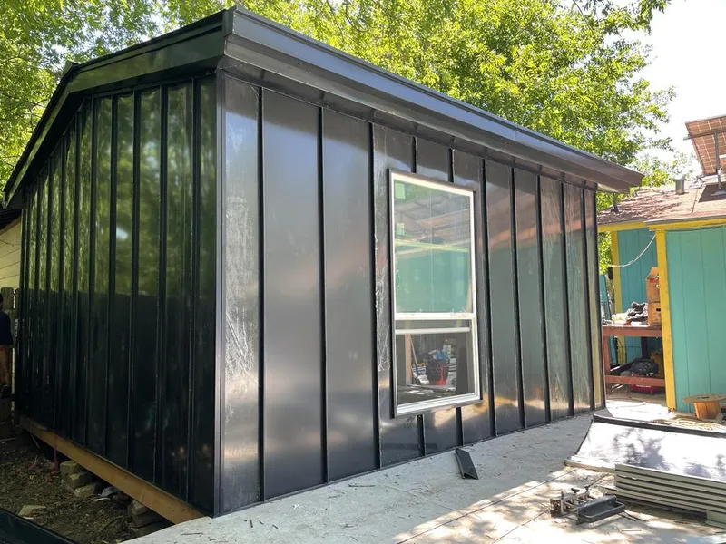 Black standing seam metal wall panels for Metal Roof Installation in California Polytechnic State University