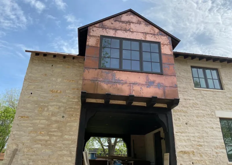 Copper metal panel facade on a stone building for Metal Roof Coating in California Polytechnic State University