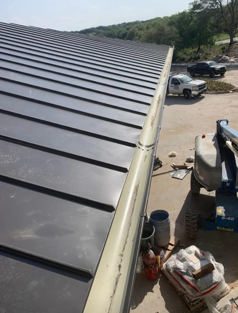 Standing seam panel and gutter detail on a metal roofing jobsite in California Polytechnic State University